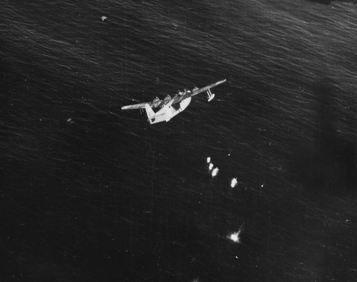 Lt. Guy M. Thompson Jr., of Patrol Bombing Squadron (VPB) 116 flies a Consolidated PB4Y-1 to protect <em>Salmon</em> during her return voyage, and detects and shoots down this Japanese Kawanishi H8K2 Type 2 Emily flying boat about 40 miles from the crippled submarine, November 1, 1944. <em>Naval History and Heritage Command</em>