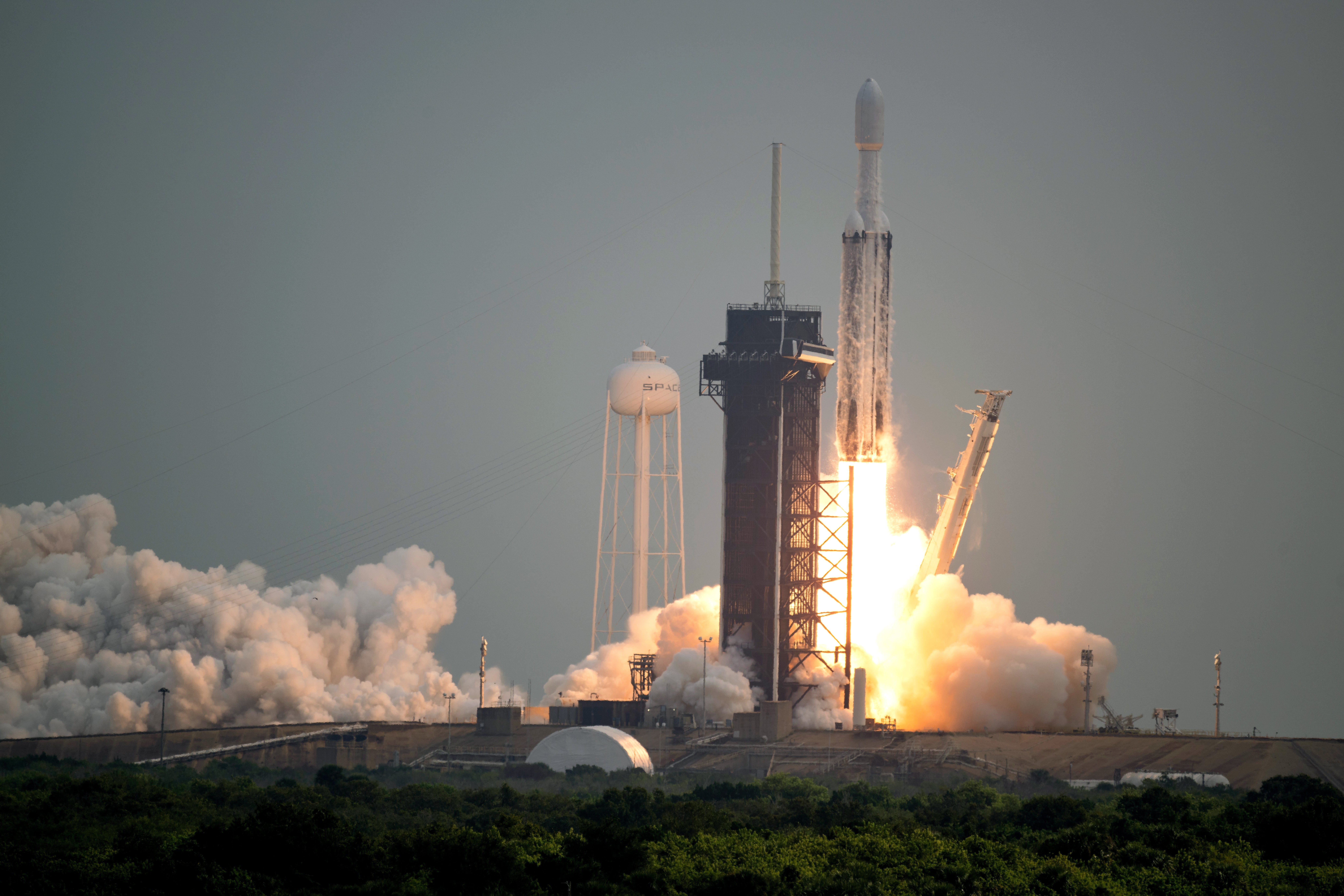 CAPE CANAVERAL, FLORIDA - OCTOBER 13: In this handout provided by NASA, a SpaceX Falcon Heavy rocket with the Psyche spacecraft onboard is launched from Launch Complex 39A, October 13, 2023 at NASA's Kennedy Space Center in Cape Canaveral, Florida. NASA's Psyche spacecraft will travel to a metal-rich asteroid by the same name orbiting the Sun between Mars and Jupiter to study its composition. The spacecraft also carries the agency's Deep Space Optical Communications technology demonstration, which will test laser communications beyond the Moon. (Photo by Aubrey Gemignani/NASA via Getty Images)