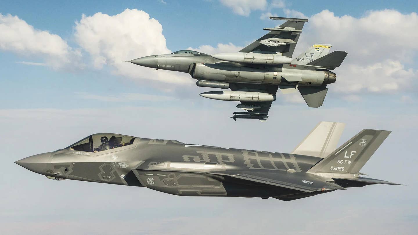 An F-35A Joint Strike Fighter and an F-16C Viper fly together. <em>USAF</em>