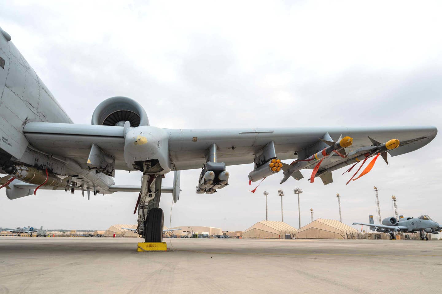 The seven-round 70mm rocket pod can be seen here just inboard of the two AIM-9M Sidewinders under the left wing of this A-10. <em>USAF</em>