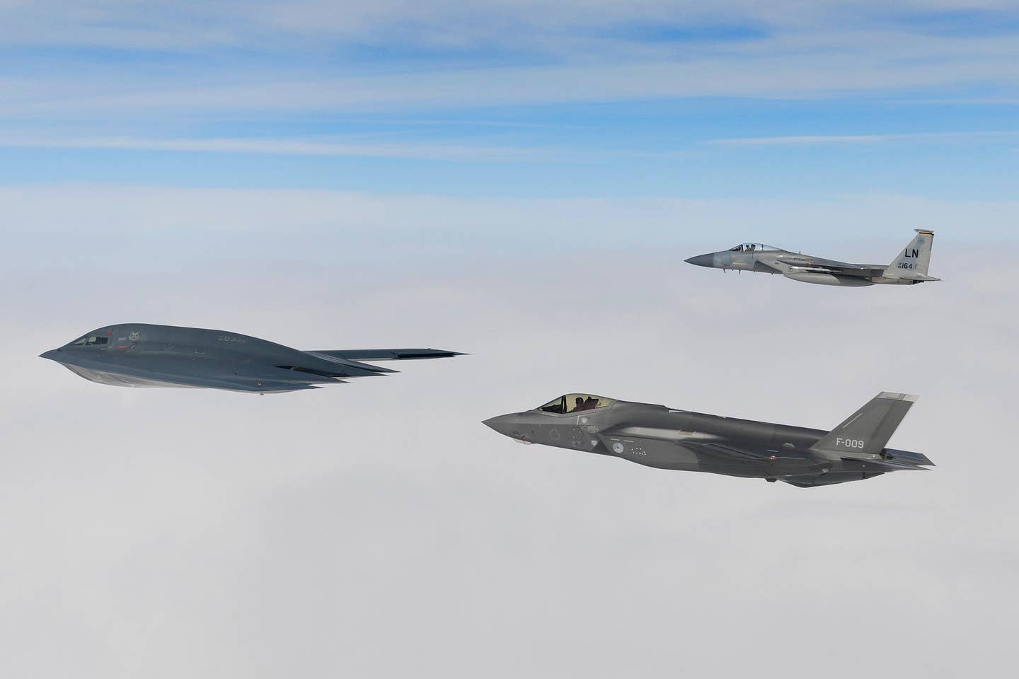 A B-2A Spirit bomber assigned to the 509th Bomb Wing, a Royal Netherlands Air Force F-35A, and a U.S. Air Force F-15C Eagle assigned to the 48th Fighter Wing, conduct aerial operations in support of Bomber Task Force Europe 20-2 over the North Sea March 18, 2020. <em>U.S. Air Force photo/ Master Sgt. Matthew Plew</em>
