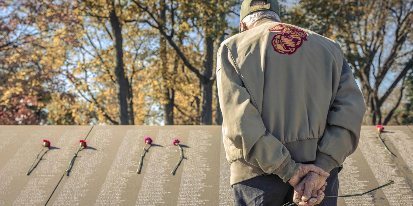 A U.S. Marine Corps Korean War veteran searches the names of those who lost their life during the Korean War at the Korean War Memorial during a reunion for those who fought at the Battle of the Chosin Reservoir in Washington, DC on Nov. 3, 2023. Veterans of the Battle of Chosin Reservoir, also known as The Chosin Few, traveled from across the country to meet with other Marines who fought by their side