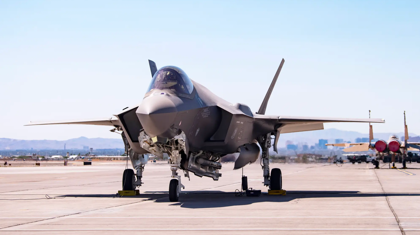 An F-35A carrying a B61-12 Joint Test Assembly sits on the flight line at Nellis Air Force Base, Nevada, on September 21, 2021. The bomb itself is not visible, but the jet also carries a pair of AIM-120 AMRAAM air-to-air missiles in its weapons bays.&nbsp;<em>U.S. Air Force/Airman 1st Class Zachary Rufus</em><br>
