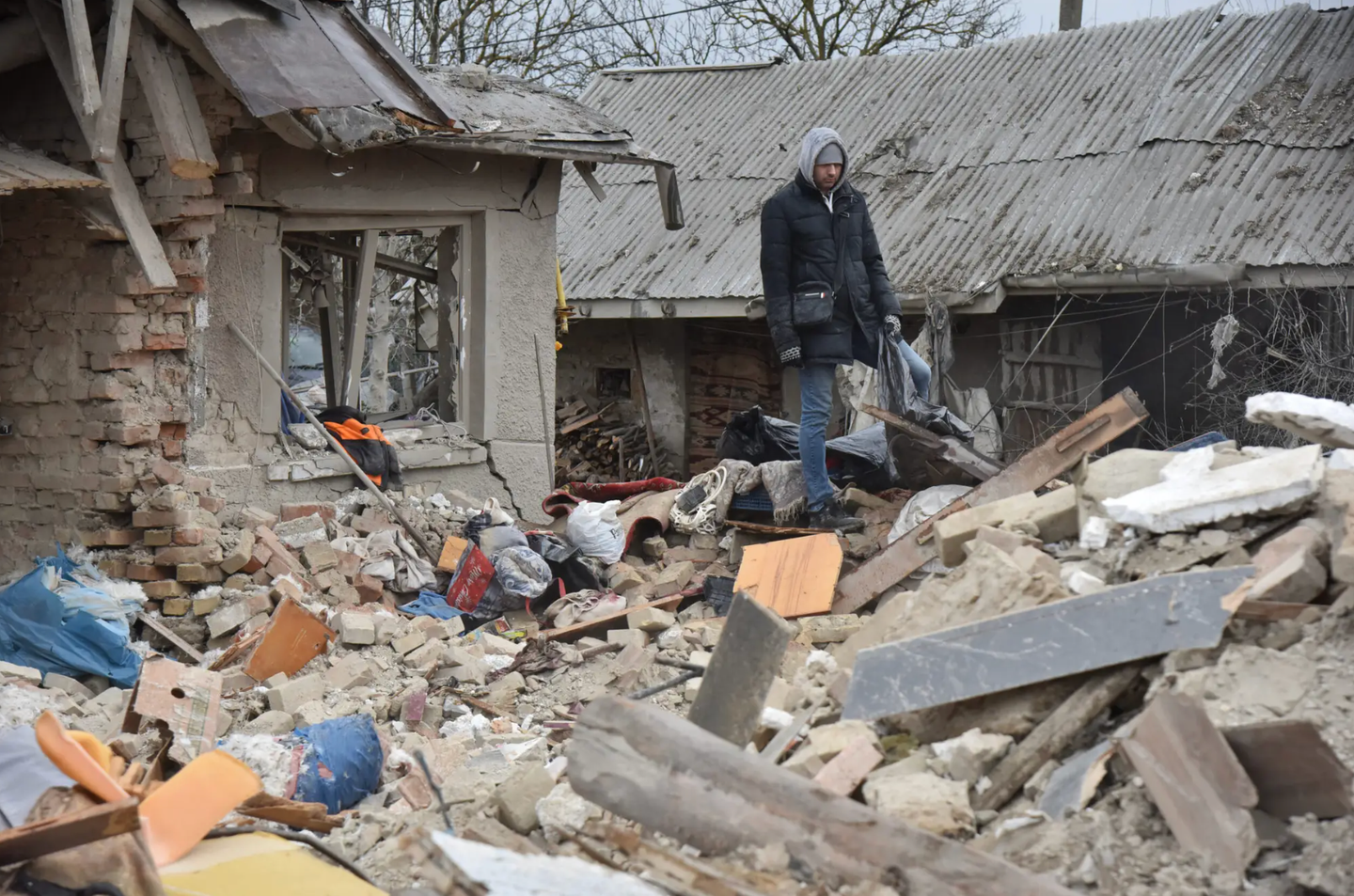 People disassemble houses destroyed by a Russian missile hitting a residential area in the village of Velika Vilshanytsia, Lviv region, Ukraine on March 9, 2023. <em>Photo by Pavlo Palamarchuk/Anadolu Agency via Getty Images</em>