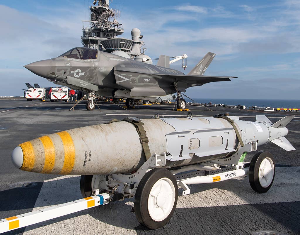 A Joint Direct Attack Munition (JDAM) is prepared for an F-35B on the amphibious assault ship USS <em>America</em> (LHA-6), during the third developmental test phase (DT-III) in 2015. <em>U.S. Navy Photo/Released</em>