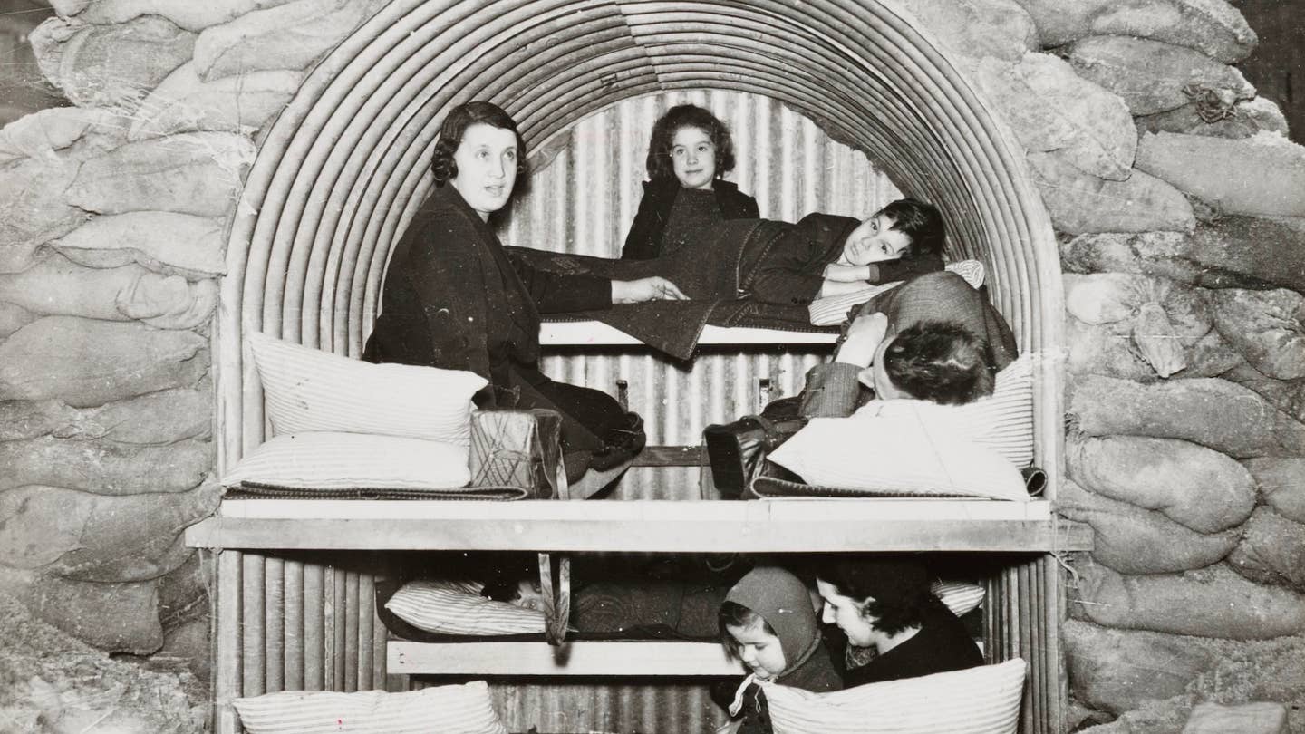A photograph of a family in an Anderson air raid shelter