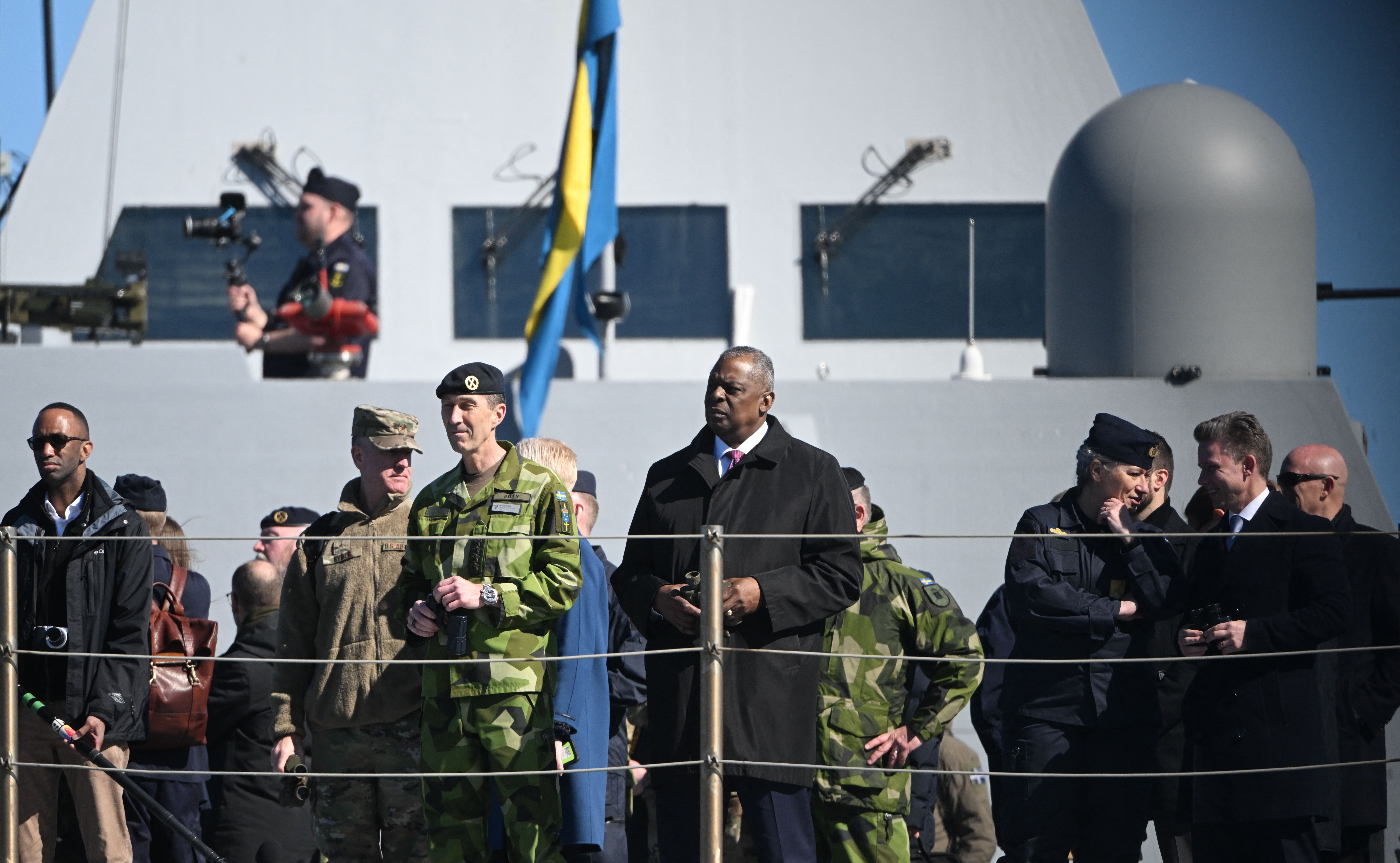 Supreme Commander of the Swedish Armed Forces General Micael Byden (C-L), Swedish Defence Minister Pal Jonson (C) and US Secretary of Defense Lloyd Austin (R) stand aboard the Visby-class corvette HMS Härnösand (K33) at the Musko Naval Base, south of Stockholm, on April 19, 2023. (Photo by Fredrik SANDBERG / TT NEWS AGENCY / AFP) / Sweden OUT (Photo by FREDRIK SANDBERG/TT NEWS AGENCY/AFP via Getty Images)