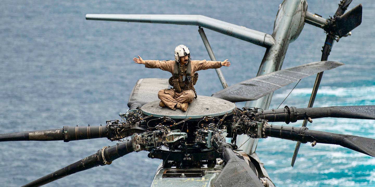 U.S. Marine Corps Sgt. Brandon CarmonaTadeo, a CH-53E Super Stallion crew chief assigned to Marine Medium Tiltrotor Squadron (VMM) 165 (Reinforced), 15th Marine Expeditionary Unit, conducts pre-flight checks on a Super Stallion before flight operations aboard the amphibious transport dock USS Somerset (LPD 25) in the Pacific Ocean, Nov. 15, 2023. The 15th MEU is currently embarked aboard the Boxer Amphibious Ready Group conducting integrated training and routine operations in U.S. 3rd Fleet