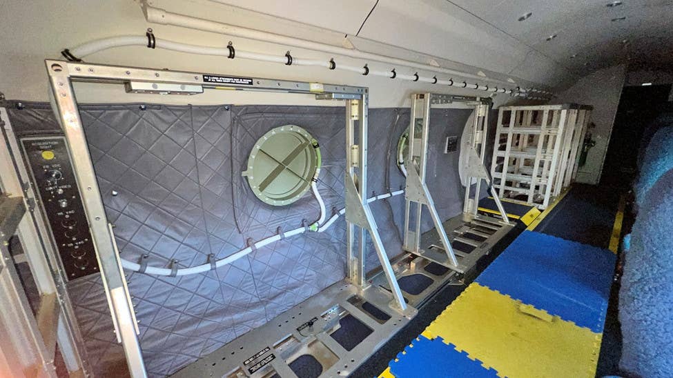 A look at some of the equipment racks, as well as the two apparent camera ports, on the left side of the NC-20G's main cabin. <em>USAF</em>