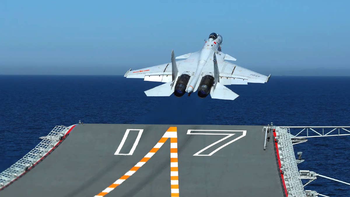A J-15 fighter takes off from the Chinese aircraft carrier <em>Shandong</em>. The ship's ski jump is clearly visible here. <em>PLAN</em>
