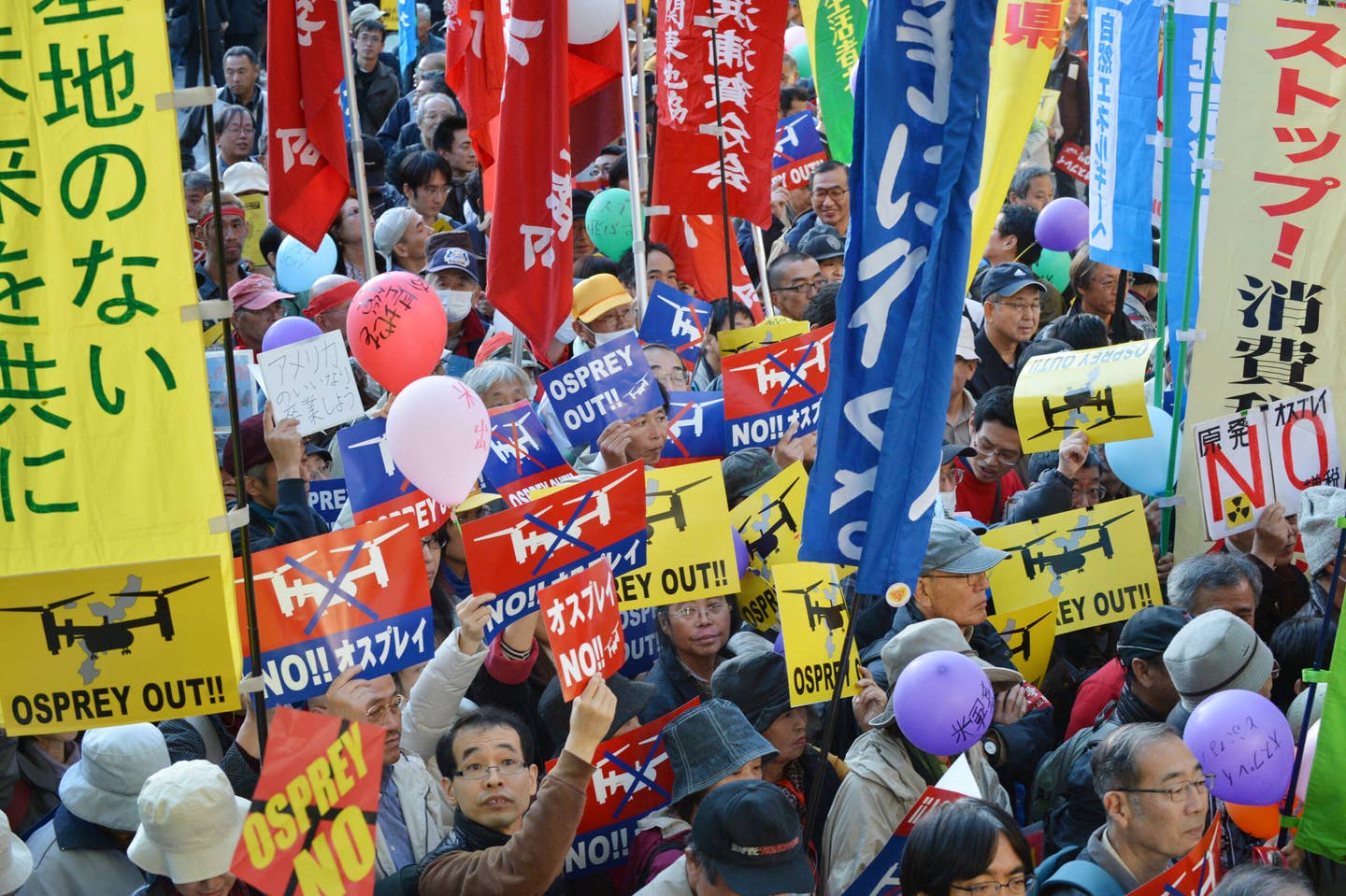 Civic group members stage a protest rally against MV-22 Osprey aircraft deployment at the Futenma Air Station in Okinawa prefecture, at a park in Tokyo on November 4, 2012. <em>KAZUHIRO NOGI/AFP via Getty Images</em>