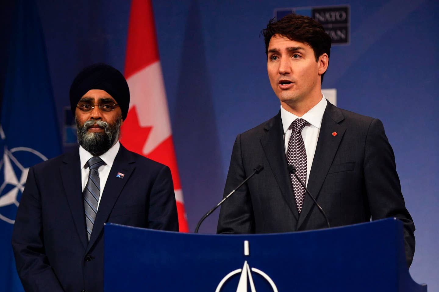 Canadian Prime Minister Justin Trudeau (right), flanked by Canadian Minister of Defense Harjit Singh Sajjan (left), at the NATO Summit in Brussels, in May 2017. <em>ERIC FEFERBERG/AFP via Getty Images</em>
