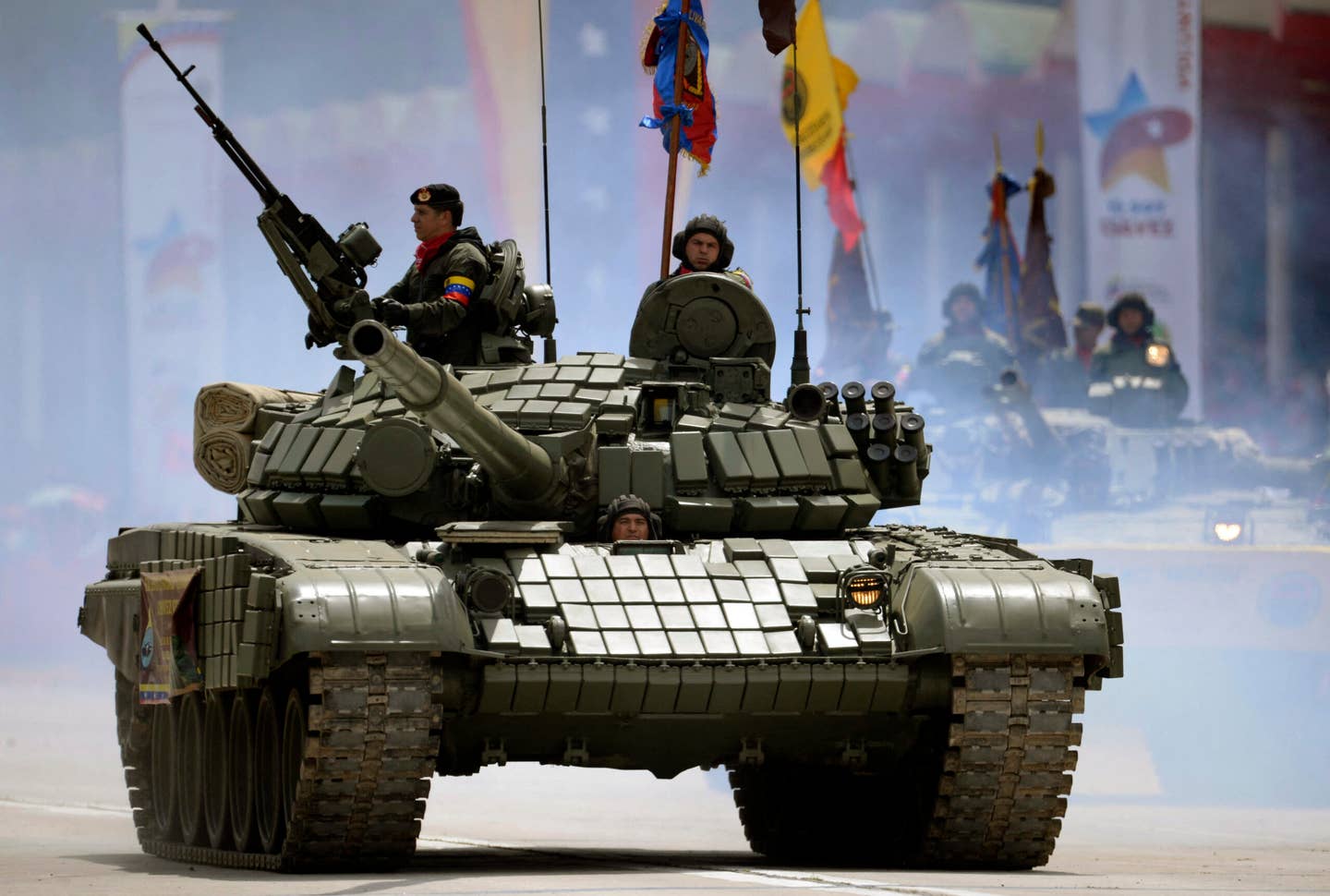 Venezuelan Army soldiers in a Russian-made T-72 tank during a military ceremony to commemorate the first anniversary of the death of President Hugo Chavez, in Caracas on March 5, 2014. <em>Photo by JUAN BARRETO/AFP via Getty Images</em>