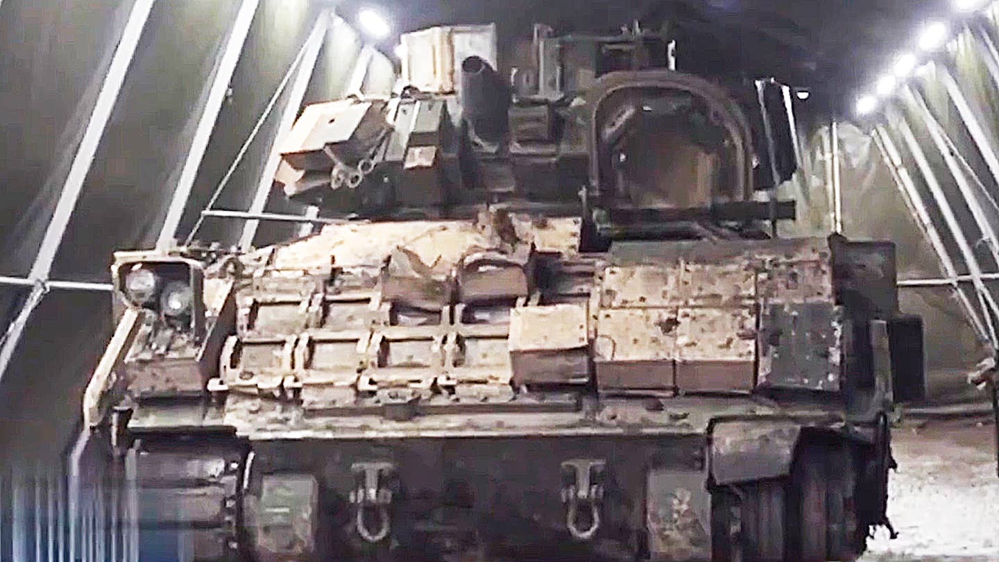 The Russians are examining a Bradley Fighting Vehicle they recently recovered from Ukraine.