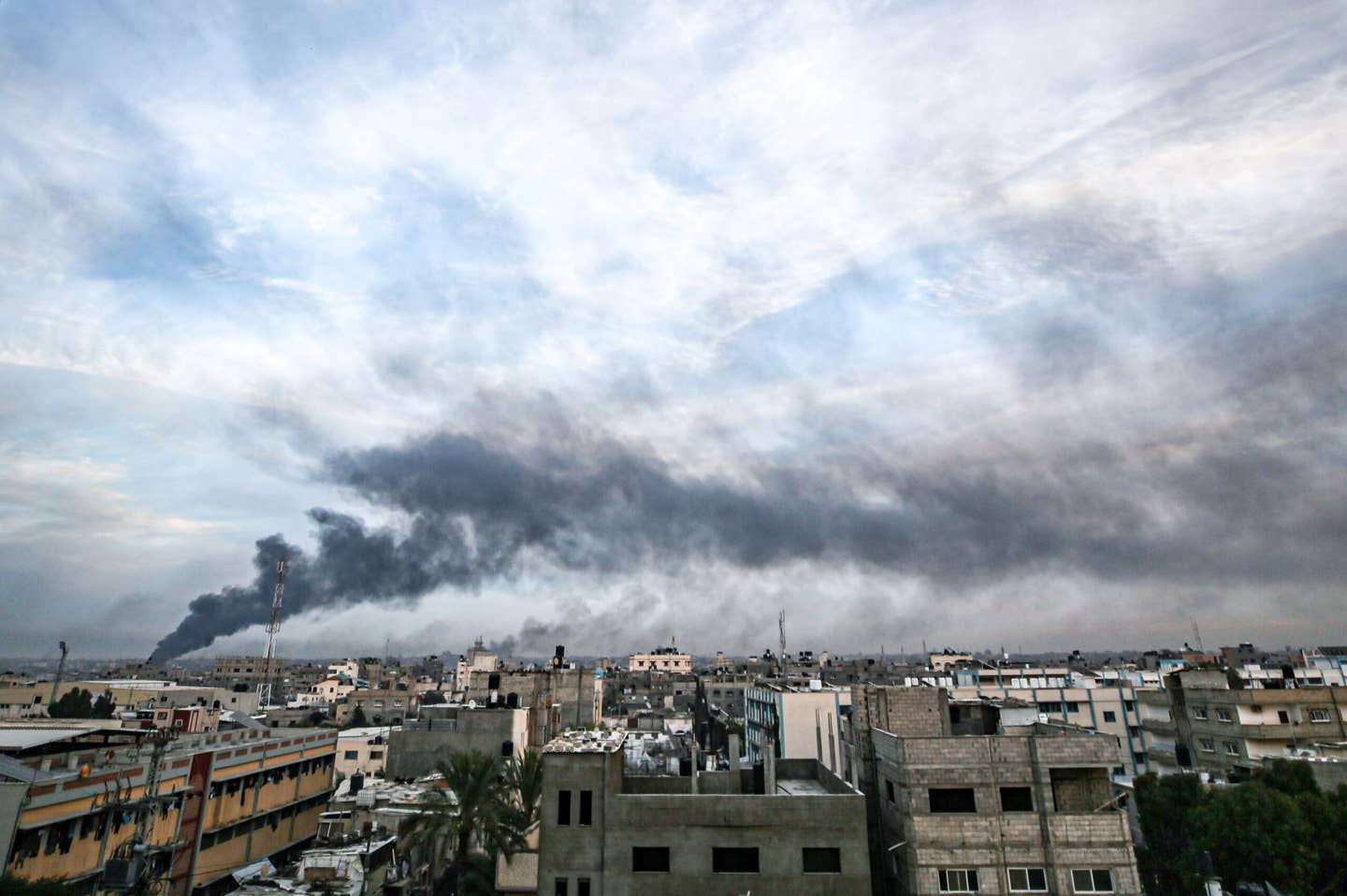 Smoke rises over destroyed buildings following the Israeli attacks on Khan Yunis, Gaza on December 10, 2023. (Photo by Jehad Alshrafi/Anadolu via Getty Images)