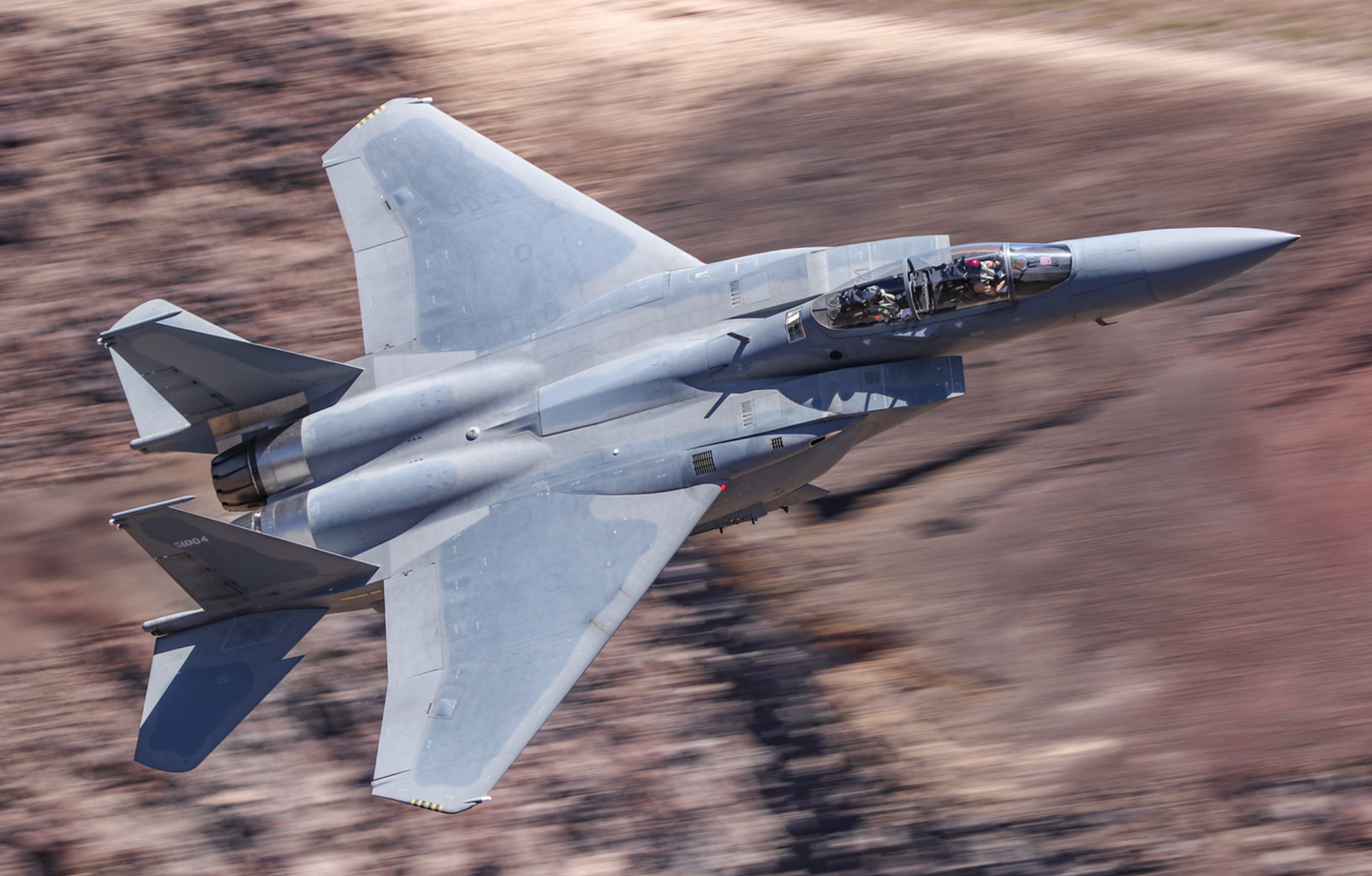 A Saudi F-15SA conducts a pre-delivery test through Rainbow Canyon, California, in 2018. <em>Christopher McGreevy</em>