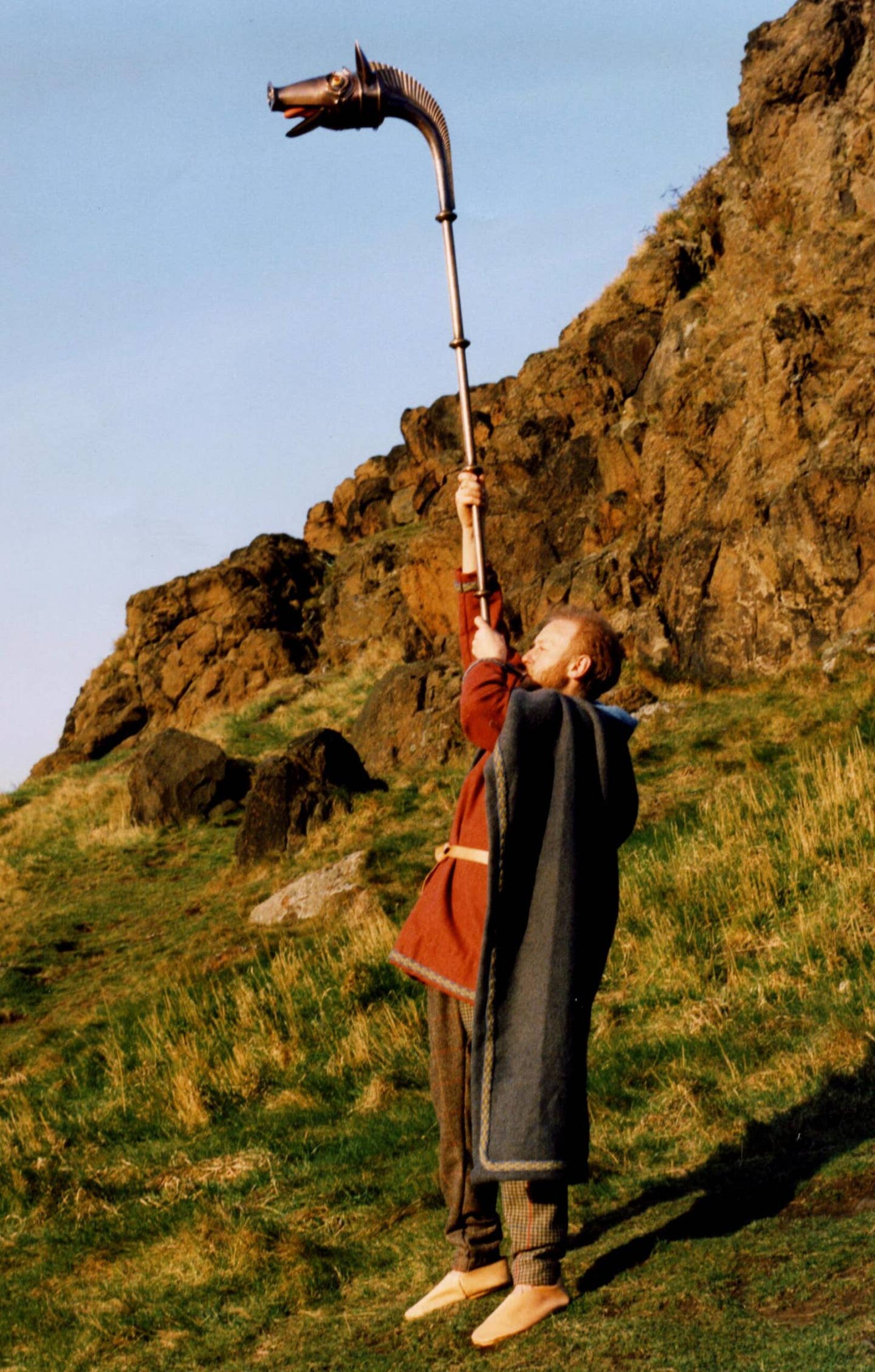 Carnyx replica being played by a historical reenactor. <em>National Museums of Scotland</em>