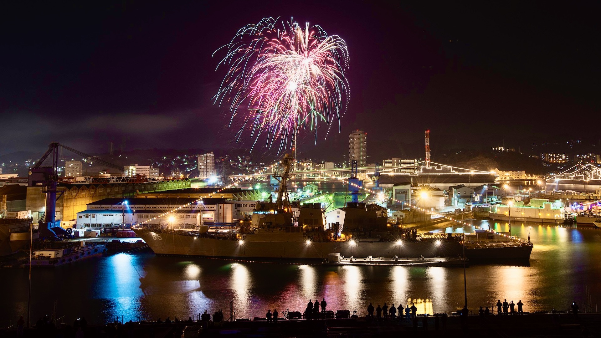 Sailors observe fireworks behind the Arleigh Burke class destroyer USS Benfold on New Year's Eve 2015, Yokosuka, Japan.