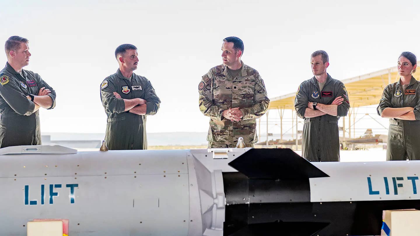 A hypersonic air-breathing air-launched cruise missile design, or a mockup thereof, is seen here in the foreground.<em> </em>This picture is from what the Air Force described as an 'orientation' about the Hypersonic Attack Cruise Missile at Edwards Air Force Base earlier this year. <em>USAF</em>
