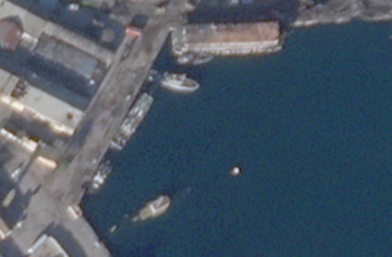 The training ship UTS-150 is seen at the bottom left of this close-up shot from the December 27 Planet Labs image. Another large ship or barge at the top appears to have sustained damage, too.<em> PHOTO © 2023 PLANET LABS INC. ALL RIGHTS RESERVED. REPRINTED BY PERMISSION</em>