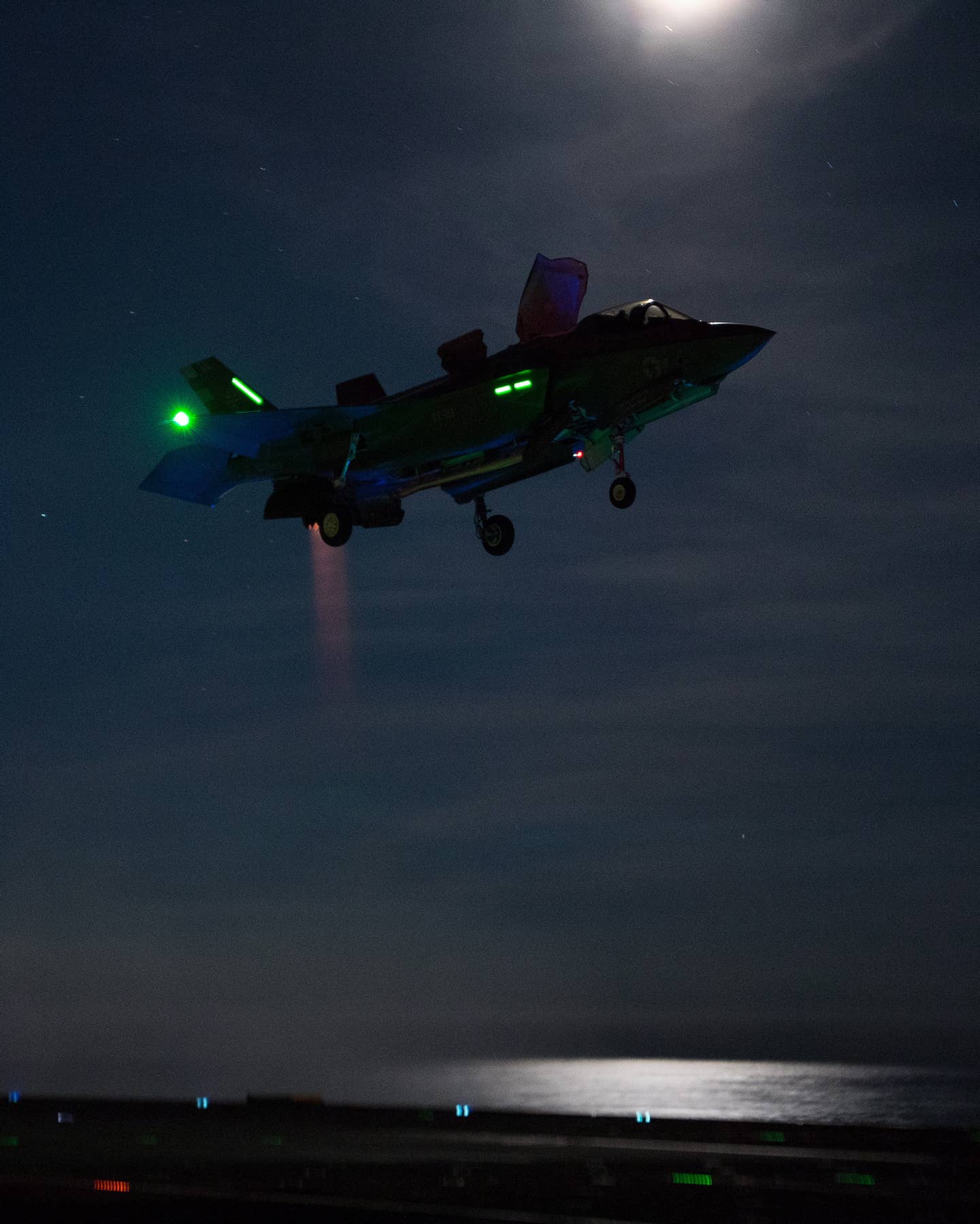 An F-35B during night flying trials aboard HMS <em>Queen Elizabeth</em>, as part of flight testing off the east coast of the United States in 2018. <em>U.S. Navy <em>photo</em> by Dane Wiedmann</em>