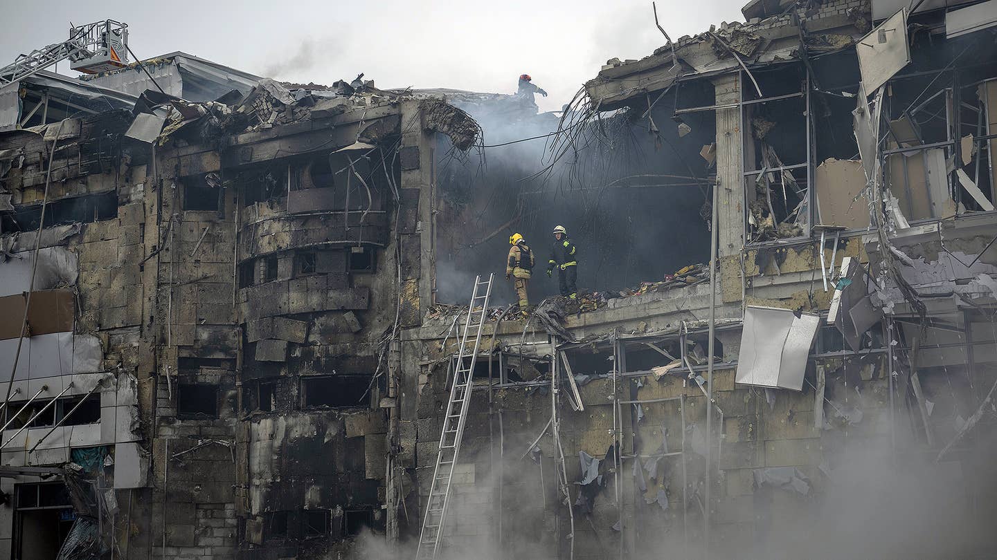 Officials work around the destruction after Russian airstrikes which killed 6 and injured around 28 people including a baby and severely damaged vehicles, a shopping mall , a maternity hospital and other buildings according to statements of Governor of Dnipropetrovsk Serhiy Lysak in Dnipro, Ukraine on December 29, 2023.