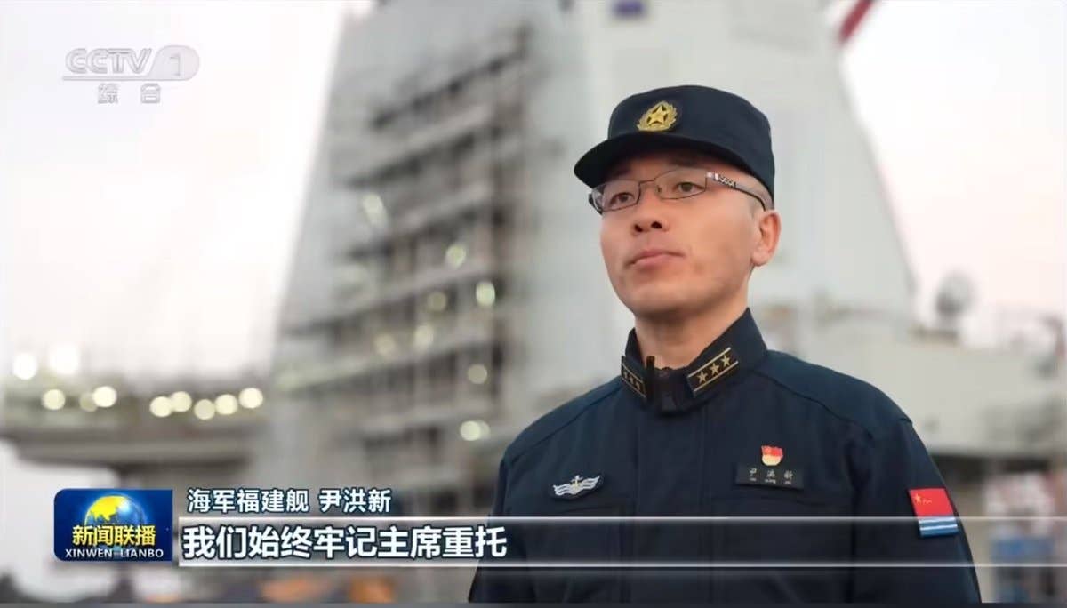 Scaffolding seen about <em>Fujian</em>'s island. <em>CCTV screencap</em>
