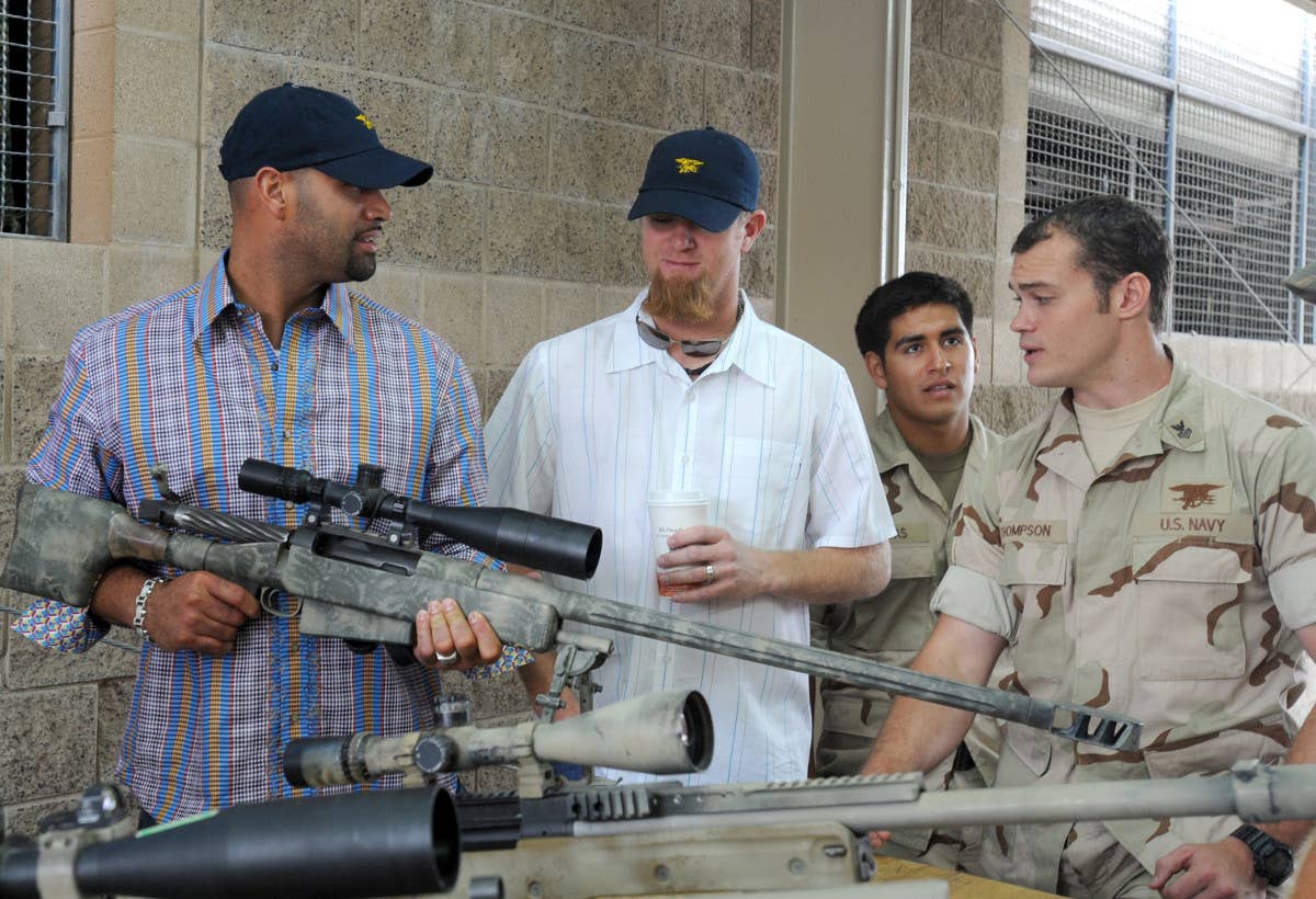 Major League Baseball star Albert Pujols holds a Mk 15 Mod 0 sniper rifle during a tour of U.S. Naval Special Warfare facilities in San Diego in 2009. <em>USN</em>