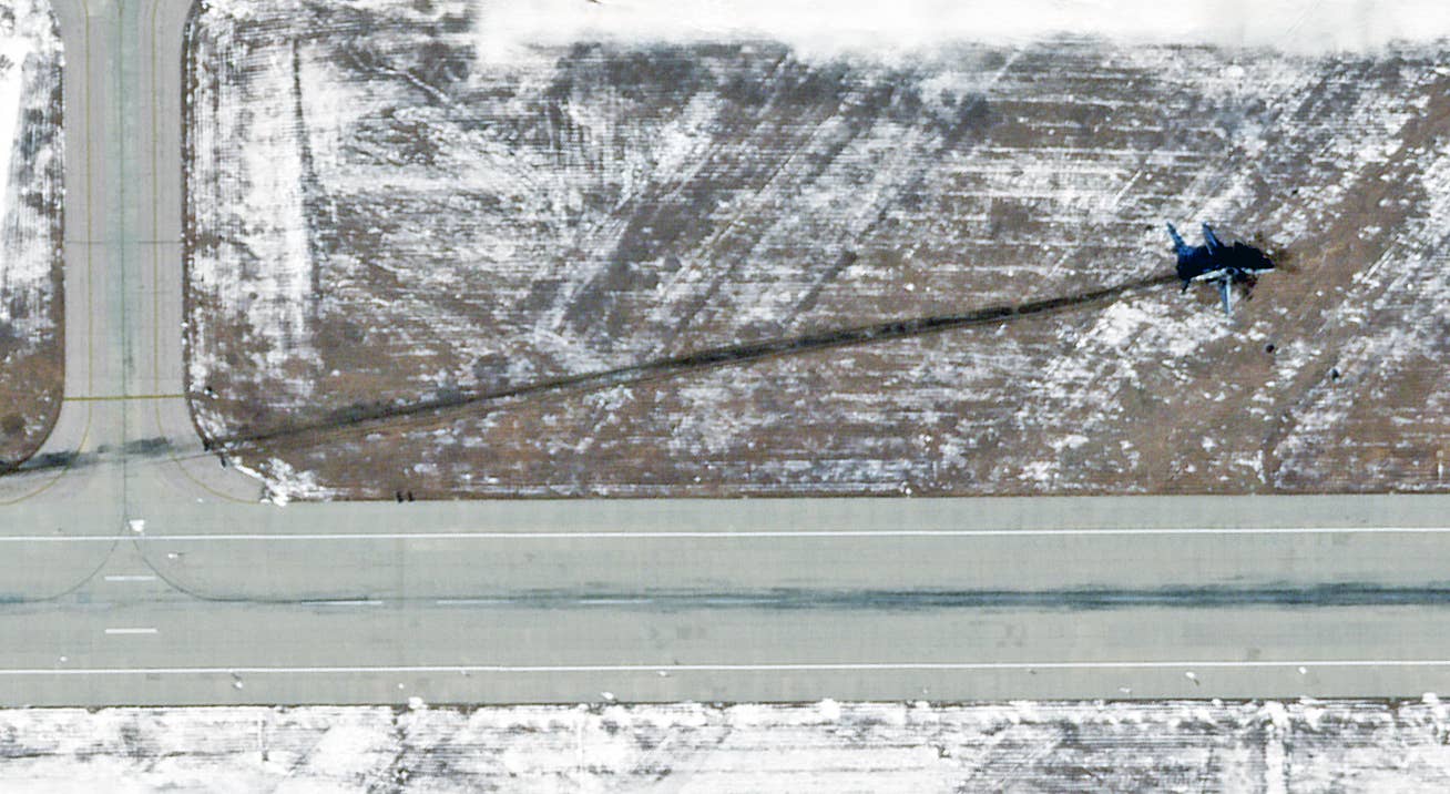 The remains of the B-1B after the aircraft came to rest adjacent to the runway at Ellsworth, in satellite imagery dated January 6, 2024. <em>PHOTO © 2024 PLANET LABS INC. ALL RIGHTS RESERVED. REPRINTED BY PERMISSION</em>
