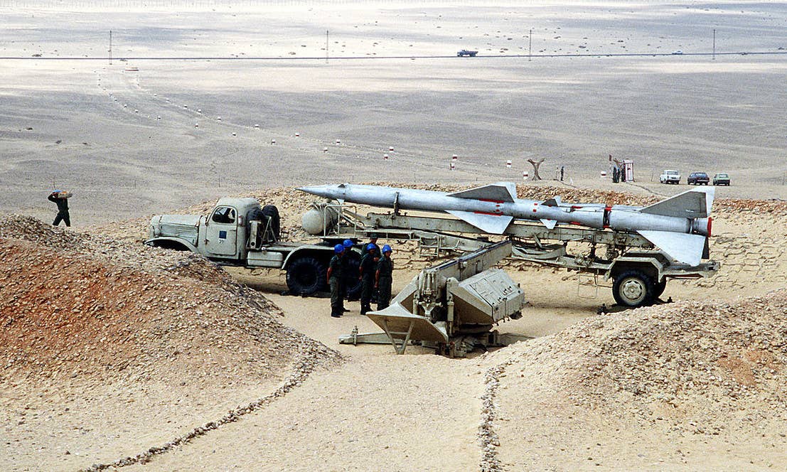 An Egyptian SA-2 surface-to-air missile on a transporter, with a static launcher seen in front, during an exercise in 1985. The Houthi's Qaher and Mohit surface-to-surface missiles are conversions of this now-dated Cold War-era design. <em>DOD</em>
