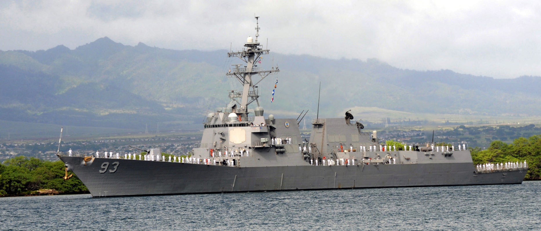The guided-missile destroyer USS Chung-Hoon maneuvers through Pearl Harbor as she departs Naval Station Pearl Harbor for a scheduled deployment to the western Pacific Ocean as part of the Boxer Expeditionary Strike Group.