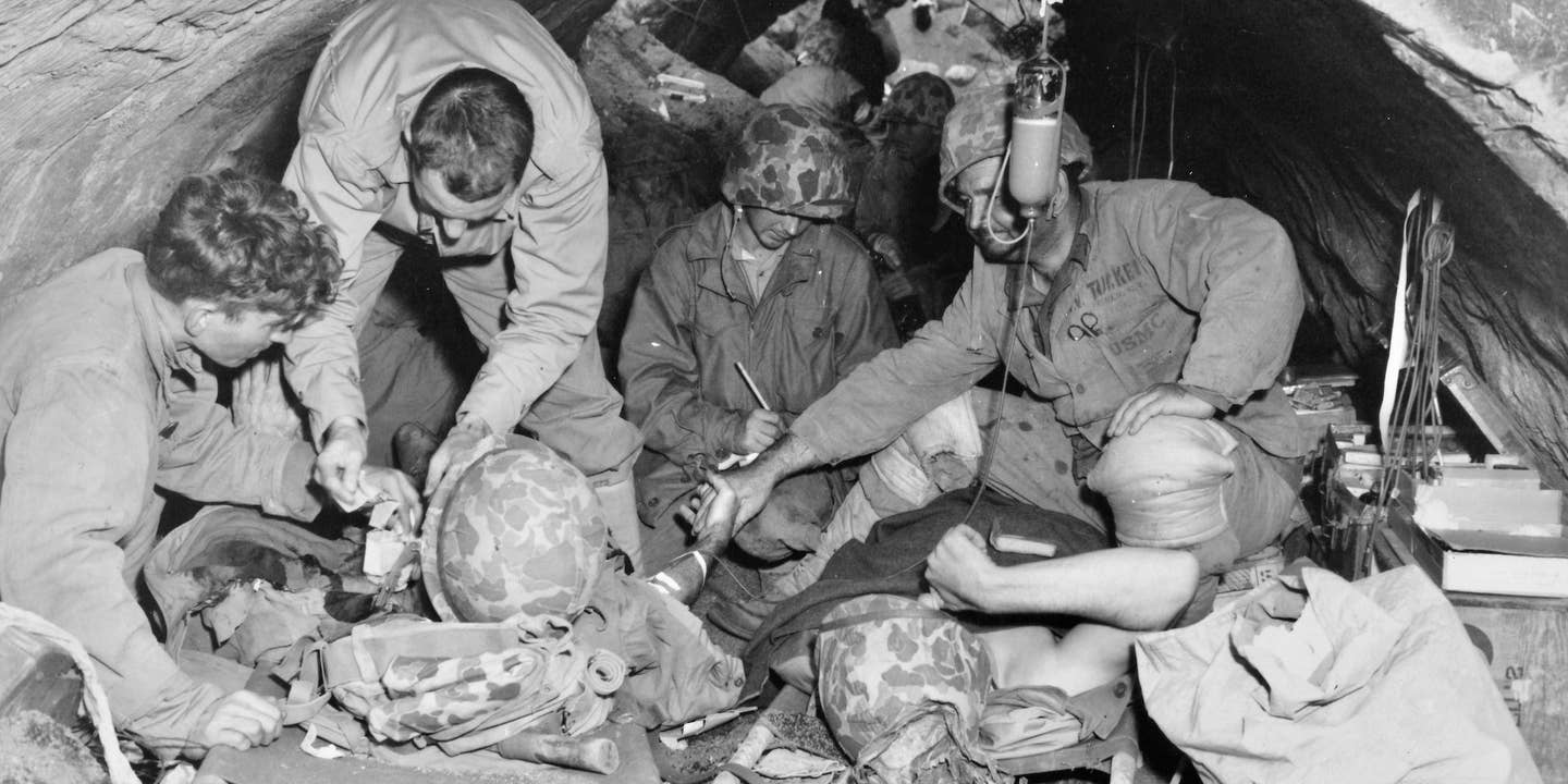 Marines, wounded in the battle for Iwo Jima, are sheltered in a Japanese concrete air raid shelter which was not completely destroyed in the three-day bombardment and aerial attack preceding the landing.