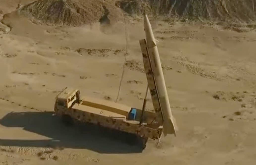 The Kheiber Shekan medium range ballistic missile and its transporter erector launcher (TEL) vehicle. (YouTube screencap)