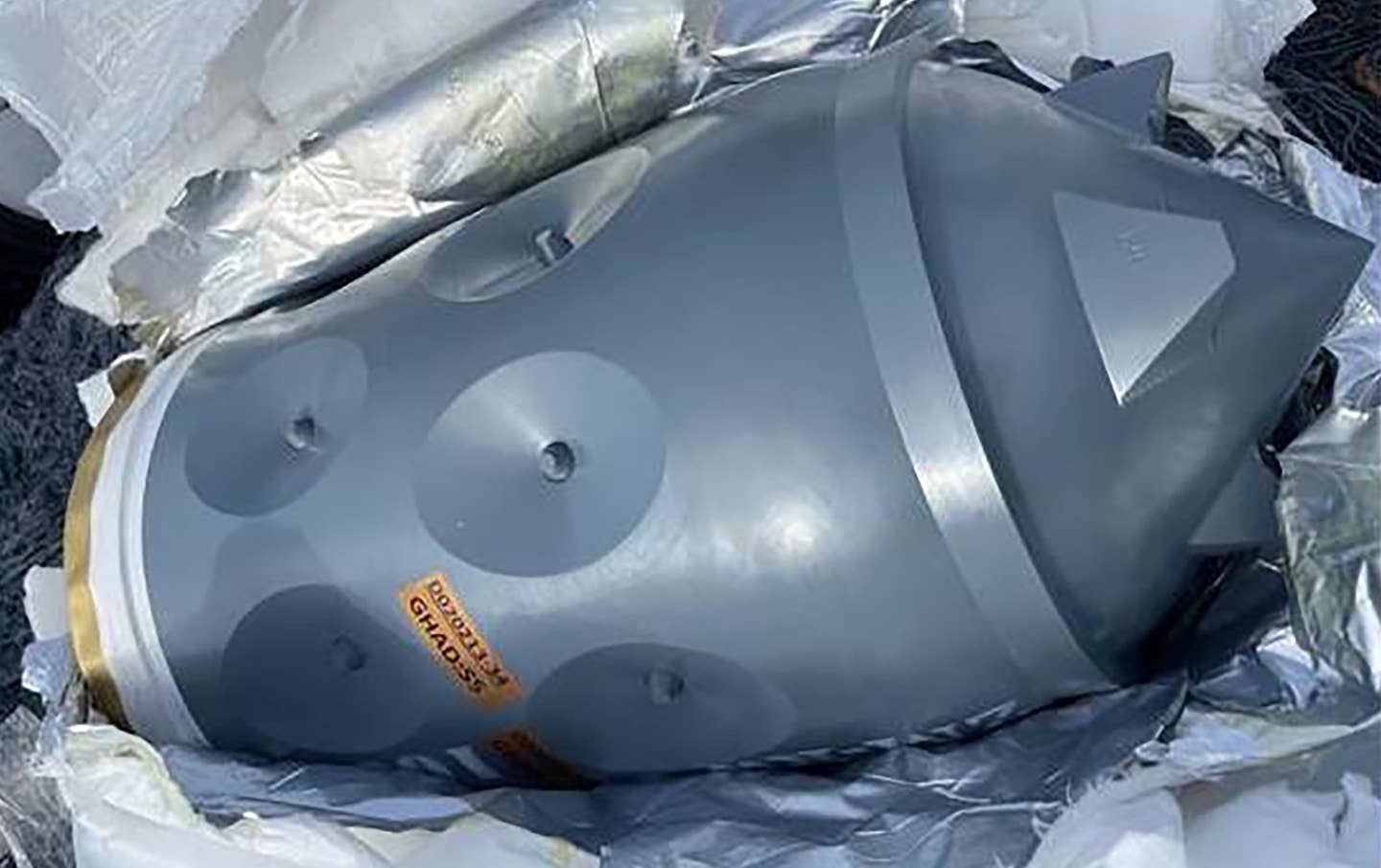 A close-up of the warhead. A label with "GHAD-55" or "GHAD-5S" written on it, as well as what appears to be a serial number, is visible. <em>CENTCOM</em>