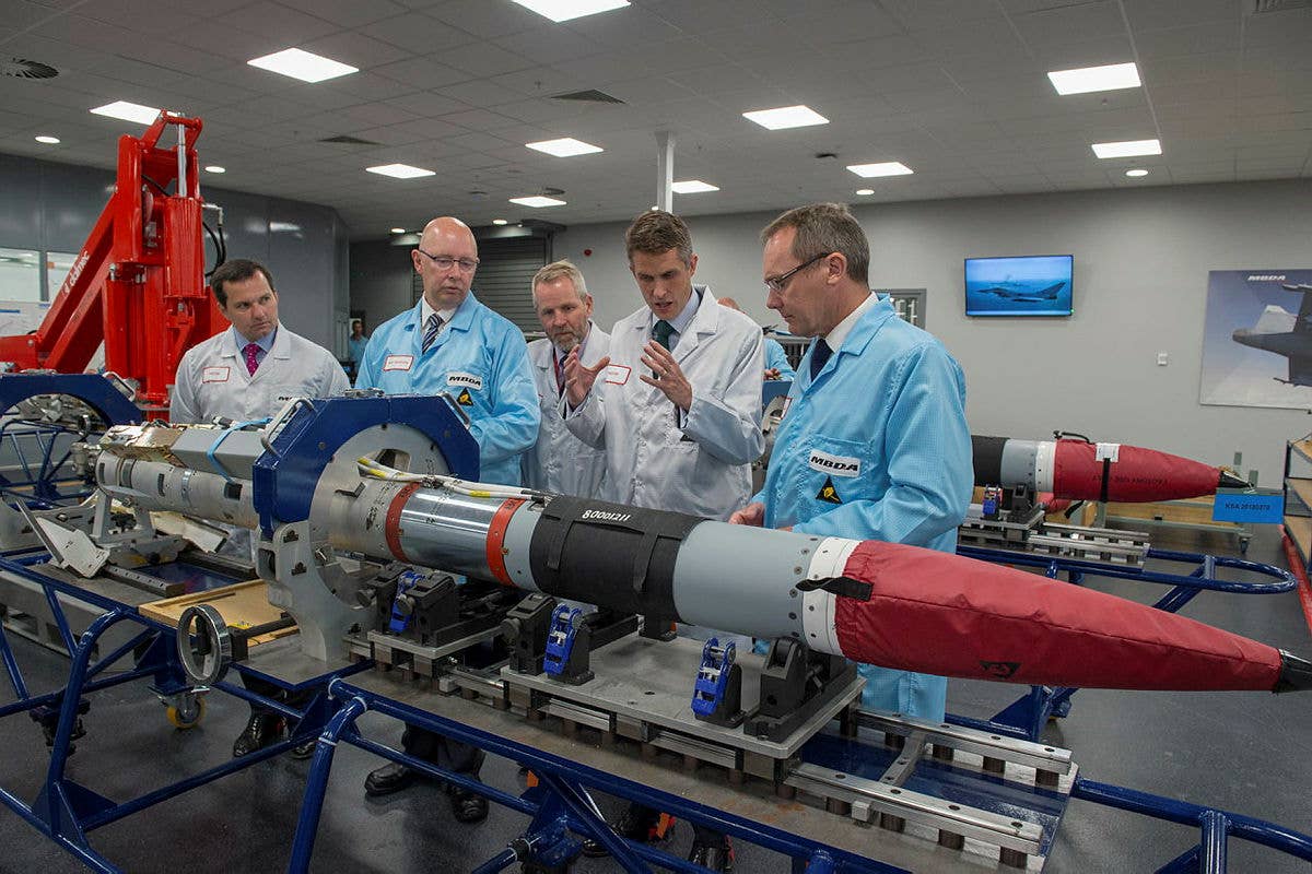 The then U.K. Secretary of State for Defense, Gavin Williamson (center), is shown a Meteor missile by MBDA staff at their factory. <em>Crown Copyright</em><br>