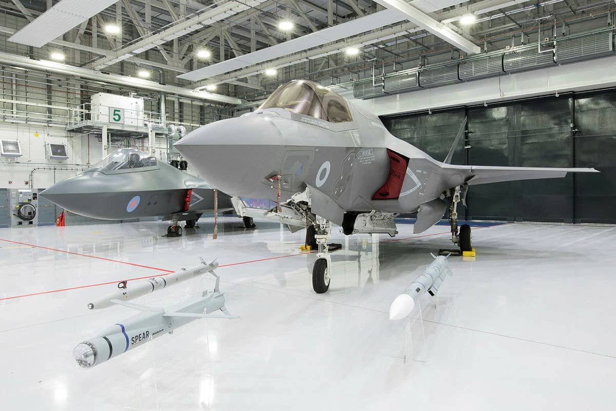 An F-35B, presented together with ASRAAM, SPEAR 3, and Meteor missiles, with a concept model for the next-generation Tempest stealth fighter seen on the far left. <em>Crown Copyright</em><br>