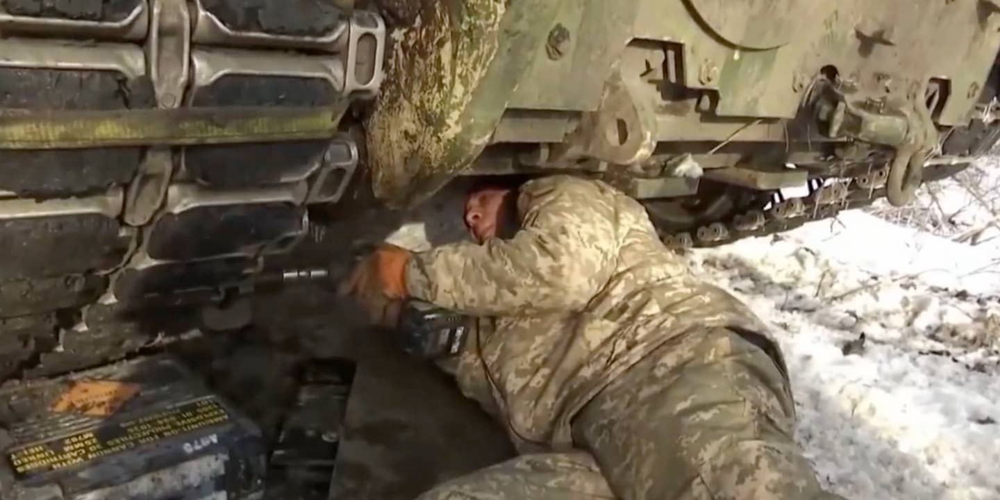 A Ukrainian mechanic working on a damaged Bradley Fighting Vehicle near Avdiivka, Donetsk Oblast. (<em>TCH</em> screencap)