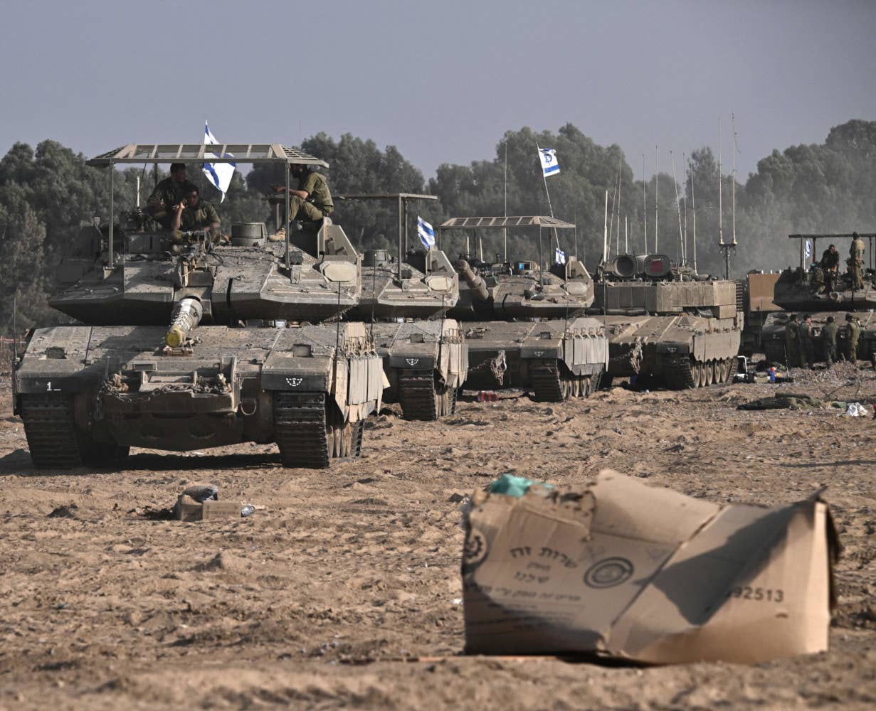 Israeli Merkava Mk 4 tanks seem in October 2023 with an earlier type of armor screen on top of their turrets. <em>ARIS MESSINIS/AFP via Getty Images</em>