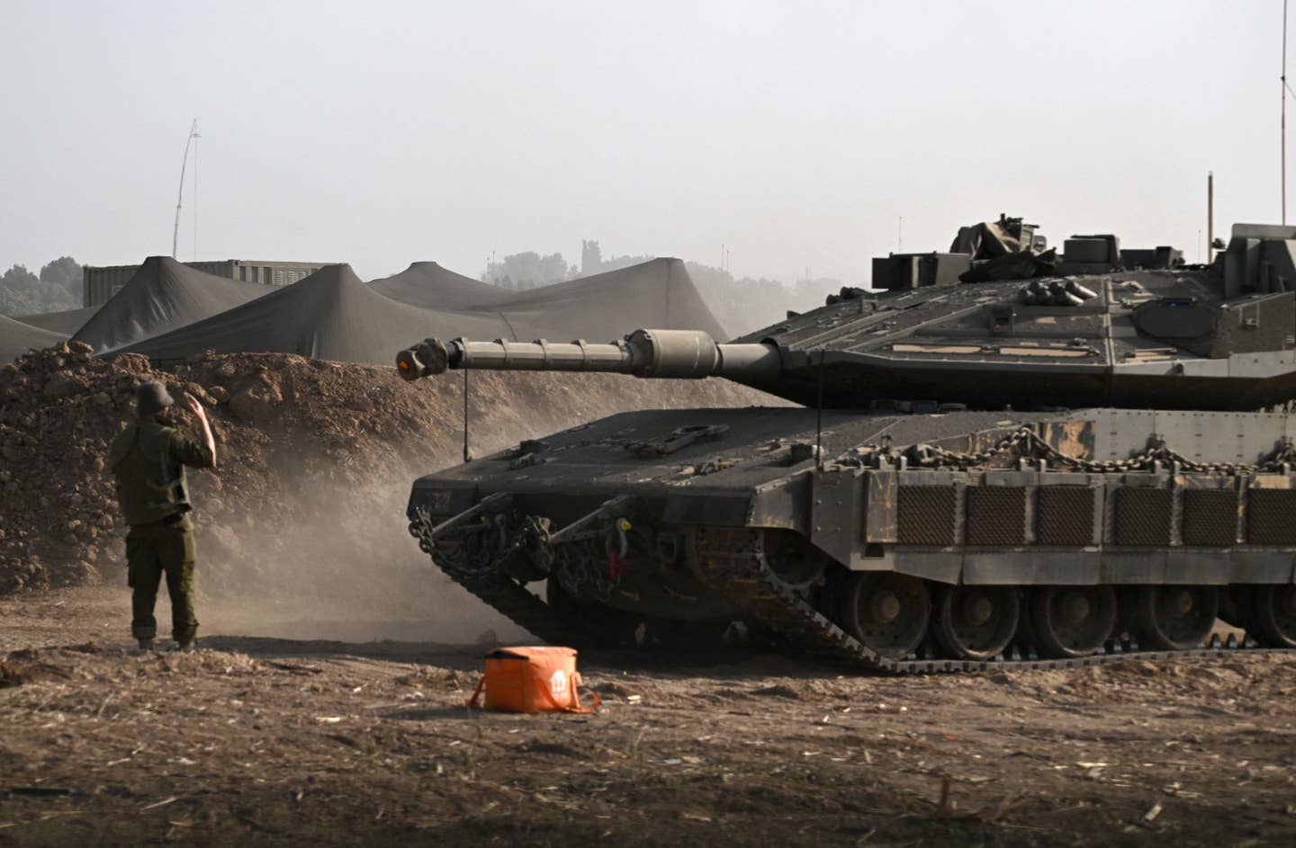 A Merkava Mk 4 seen with what looks to be a different style of add-on protection against magnet bombs on its armor skirts in October 2023. <em>ARIS MESSINIS/AFP via Getty Images</em>