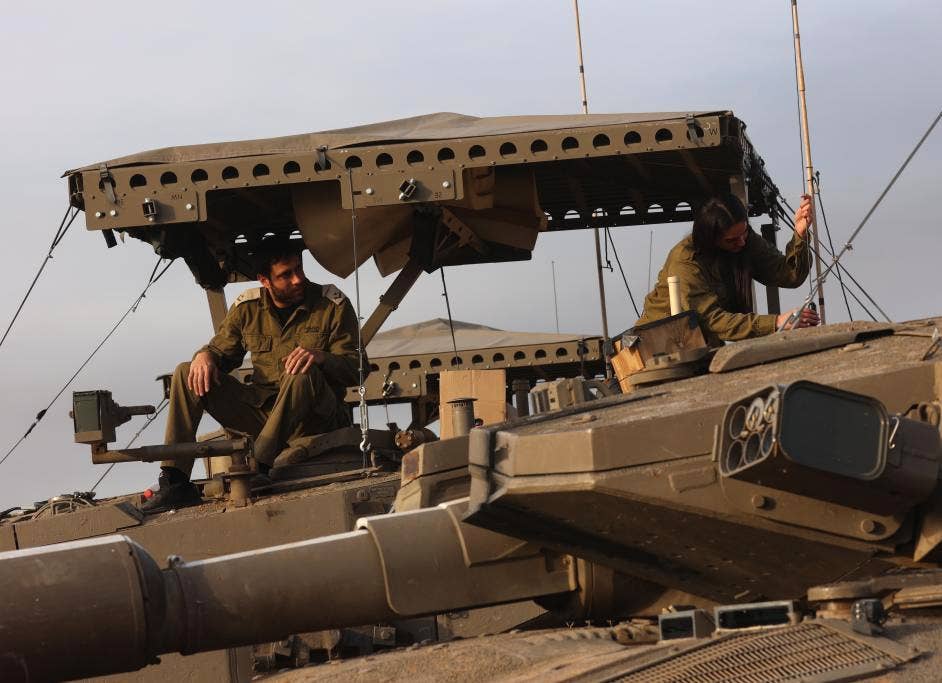 A close-up of the new armor screen design seen recently on Merkava Mk 3s. Note the sturdier-looking supports and framing and tent-like top compared to earlier designs seen in this story, as well as the wires attaching to the top of the turret. <em>Gil Cohen Magen/Xinhua</em>