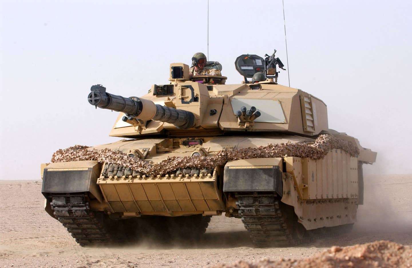 A British Army Challenger 2, attached to the 1st Royal Regiment of Fusiliers battlegroup, in action at Camp Coyote, Kuwait, in 2003. <em>Crown Copyright</em>