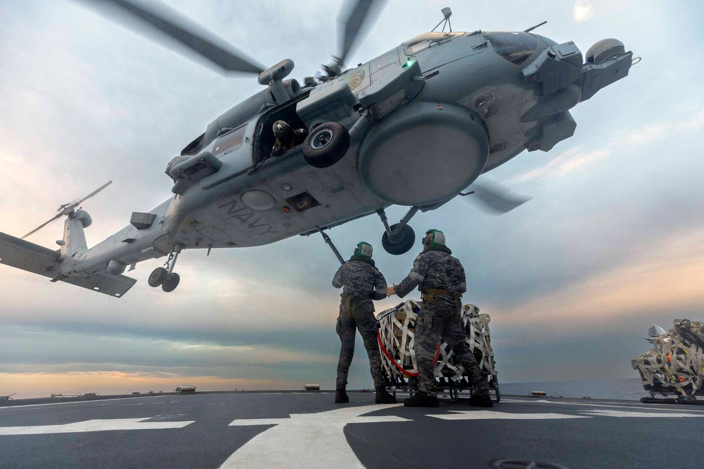 A Royal Australian Navy 808 Squadron MH-60R Romeo Seahawk conducts a vertical replenishment of the Australian <em>Anzac</em> class frigate HMAS <em>Toowoomba</em> during operations in the South China Sea in 2023, after the squadron re-equipped after retiring its NH-90s in April 2022. <em>Commonwealth of Australia, Department of Defense</em>