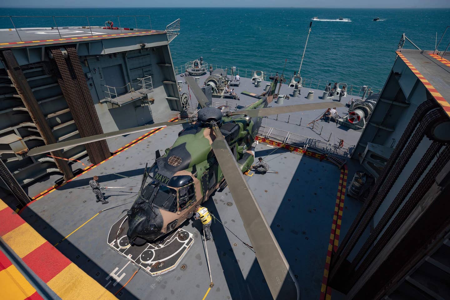 Australian Army flown NH-90 callsign Midnight is lowered into the hangar deck of the Royal Australian Navy’s Canberra class Amphibious Assault Ship HMAS Adelaide during exercises near Brisbane Queensland in 2019. <em>Pic Commonwealth of Australia, Department of Defense</em>