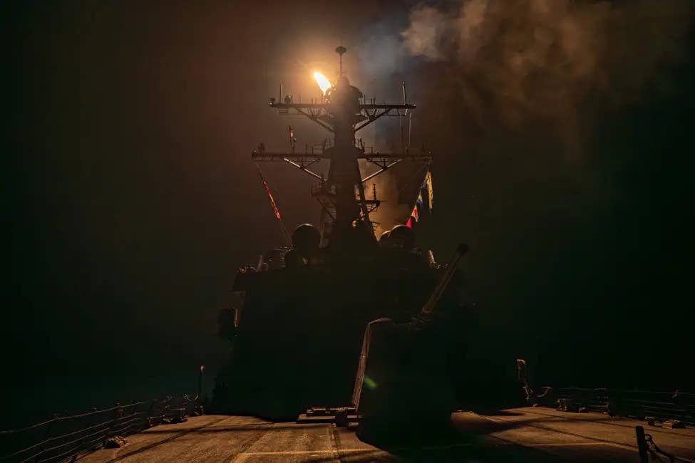 An <em>Arleigh Burke</em> class destroyer fires a Tomahawk at a Houthi target in Yemen in January 2024. <em>CENTCOM</em>