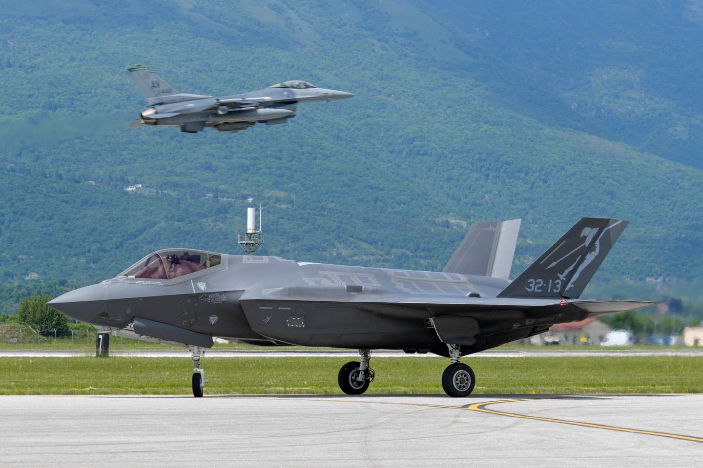 An Italian Air Force F-35A taxis while a U.S. Air Force F-16 Fighting Falcon takes off during a joint exercise at Aviano Air Base, Italy, May 21, 2021. <em>U.S. Air Force photo by Airman 1st Class Brooke Moeder</em><br>