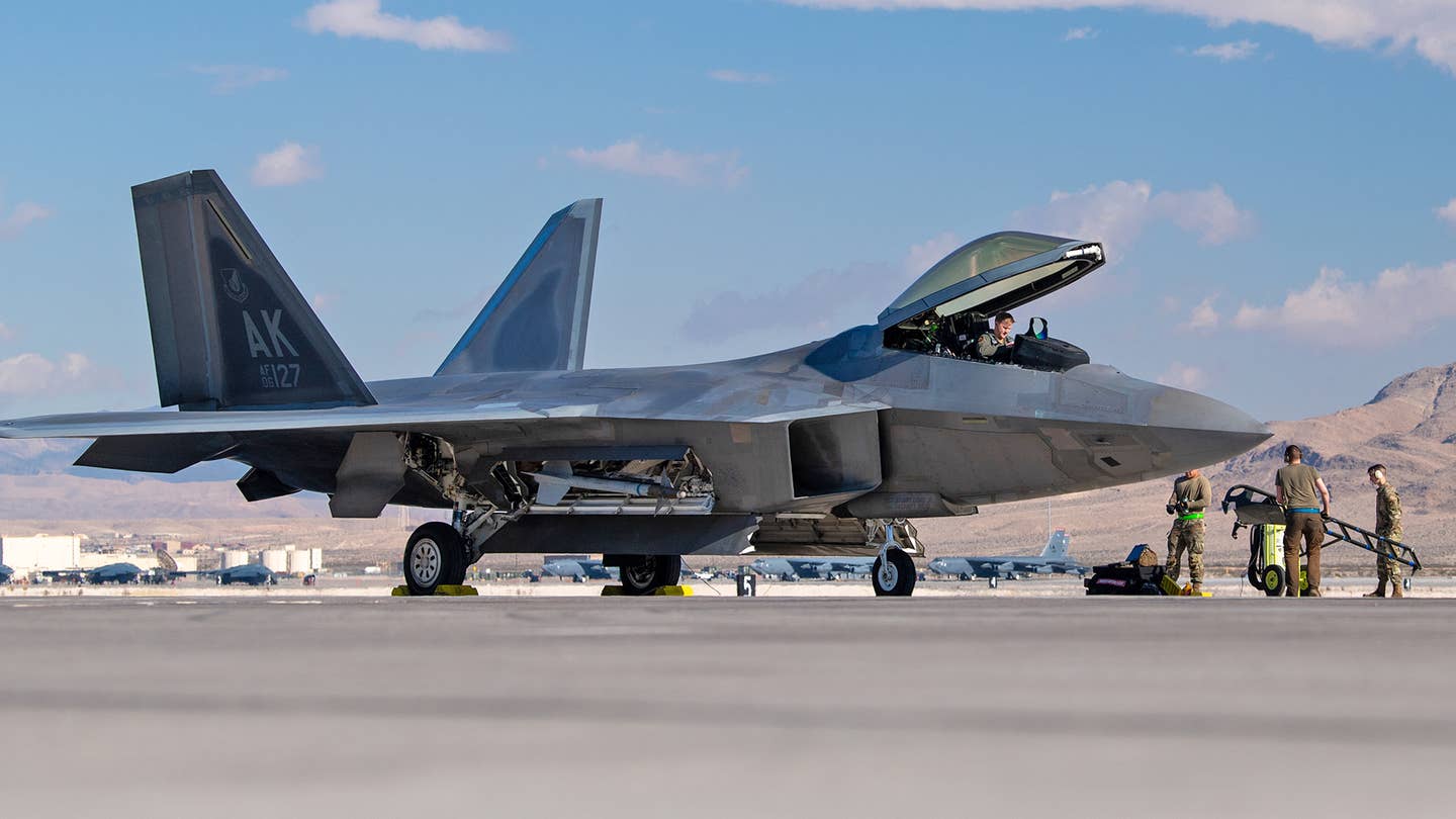 An F-22 from the 525th Expeditionary Fighter Squadron is prepared to forward deploy from Nellis AFB for Exercise Bamboo Eagle. <em>USAF/TSgt Curt Beach</em>