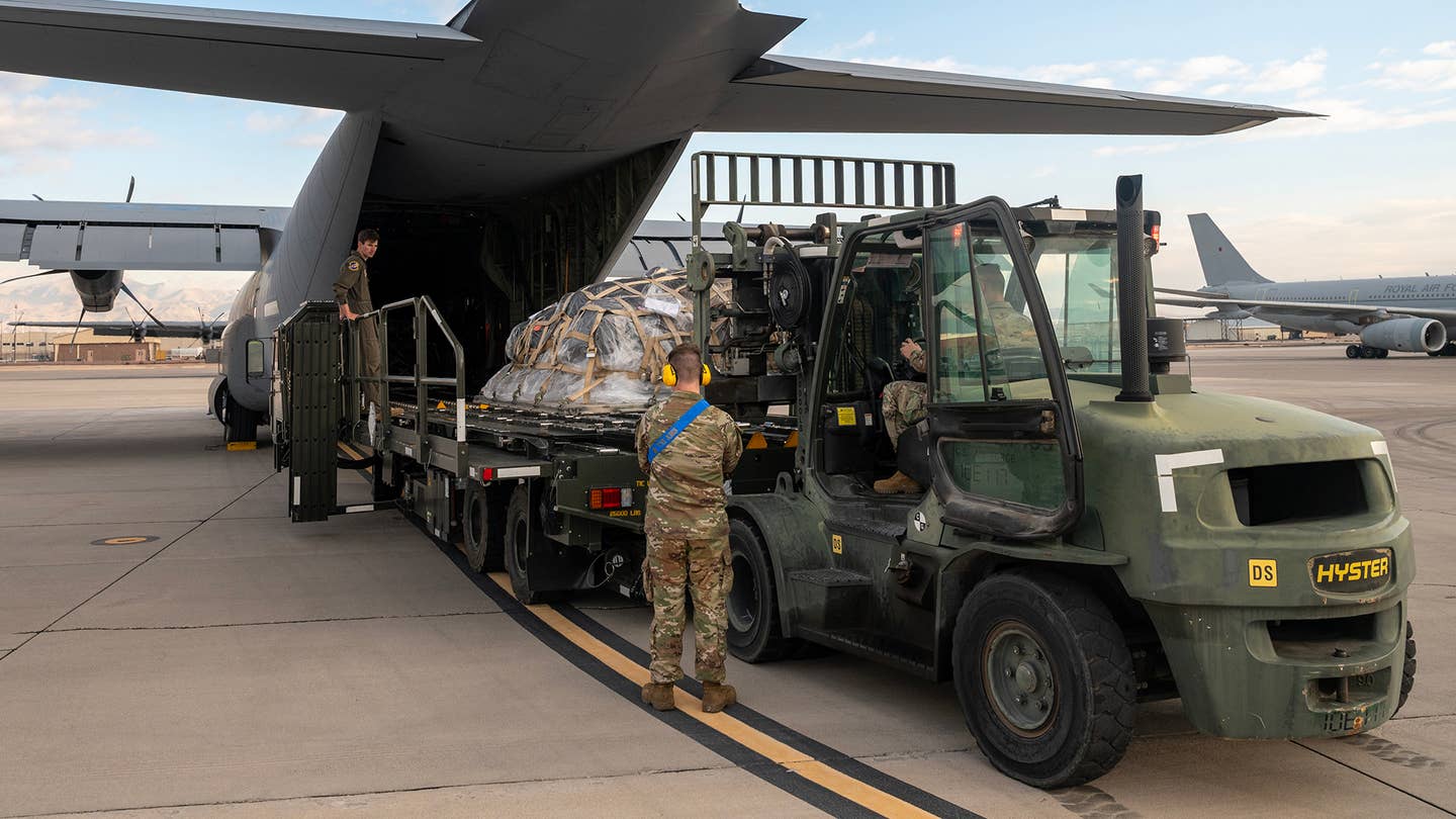 A C-130 Hercules is loaded at Nellis AFB as Red Flag participants forward-deployed to operating bases for Bamboo Eagle. <em>USAF</em>