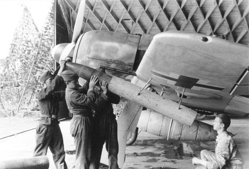A Luftwaffe Fw 190 is loaded with 21-cm-Werfergranaten (WfG. 21) rockets, to be used to attack heavy bombers, in 1943. <em>German Federal Archives</em>
