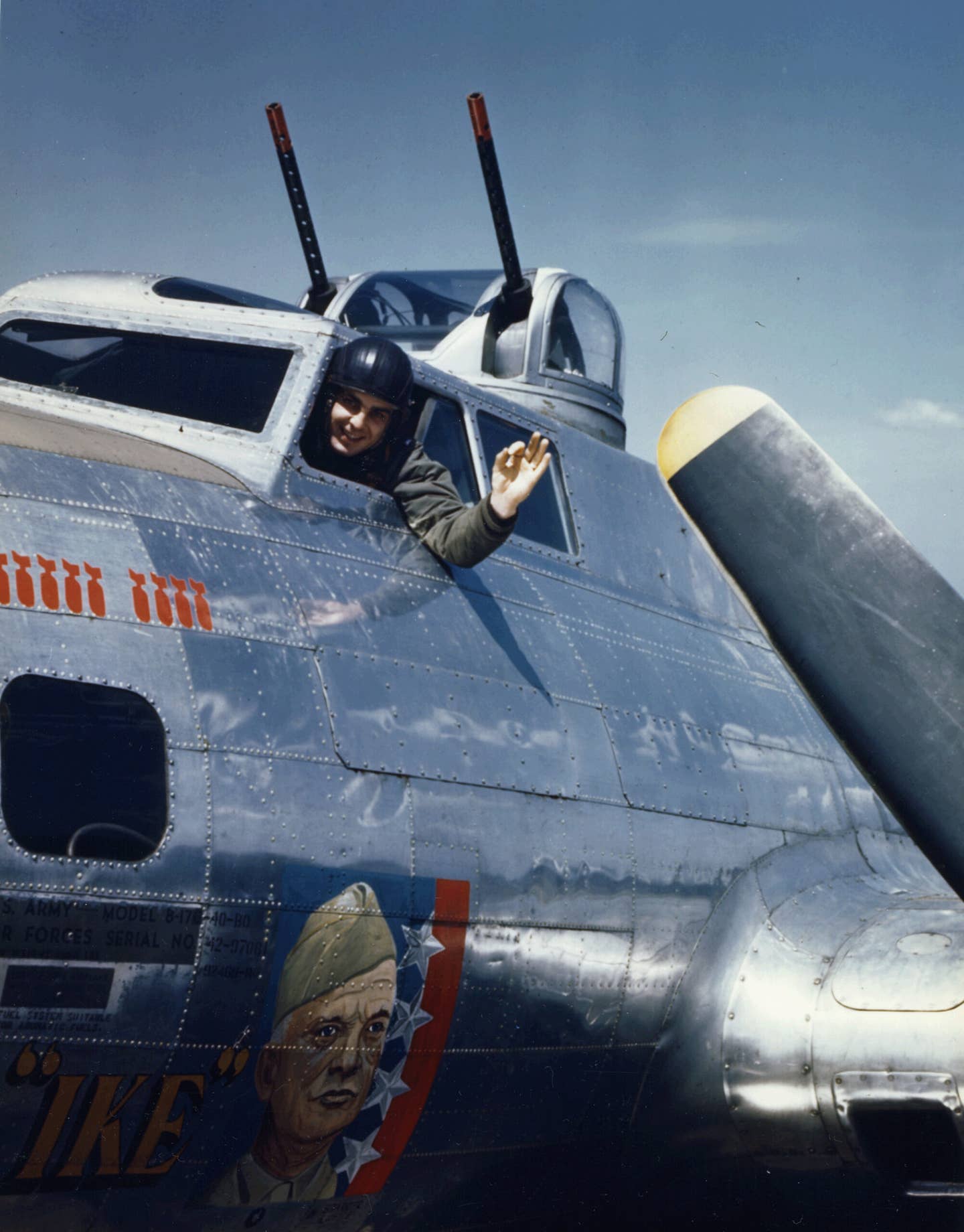 1st Lt. George H. Heilig waves and gives the okay sign from the cockpit of the <em>General Ike</em>, a B-17 from the 401st Bomb Squadron, 91st Bomb Group, Eighth Air Force, England, circa 1944. <em>Photo by PhotoQuest/Getty Images</em>