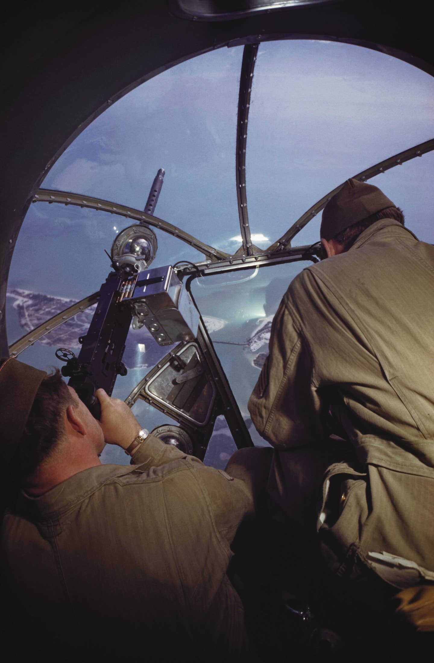 Bomber crew in the nose of a B-17 in the run-up to World War II. The limited traverse available on the gun mounted in the nose transparency is evident. <em>Photo by Ivan Dmitri/Michael Ochs Archives/Getty Images</em>